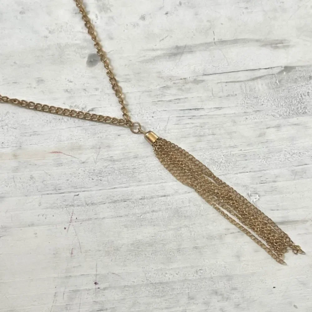 Gold tone long tassel necklace